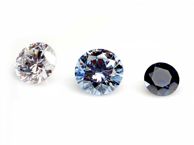 Three diamonds from ashes, one colorless, one medium blue, one dark blue