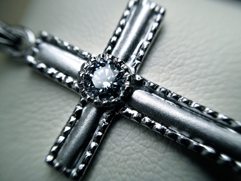 Brilliant cut diamond set into white gold cross